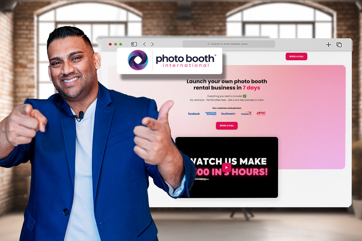 Owner of Photo Booth International in front a screen showing the company website
