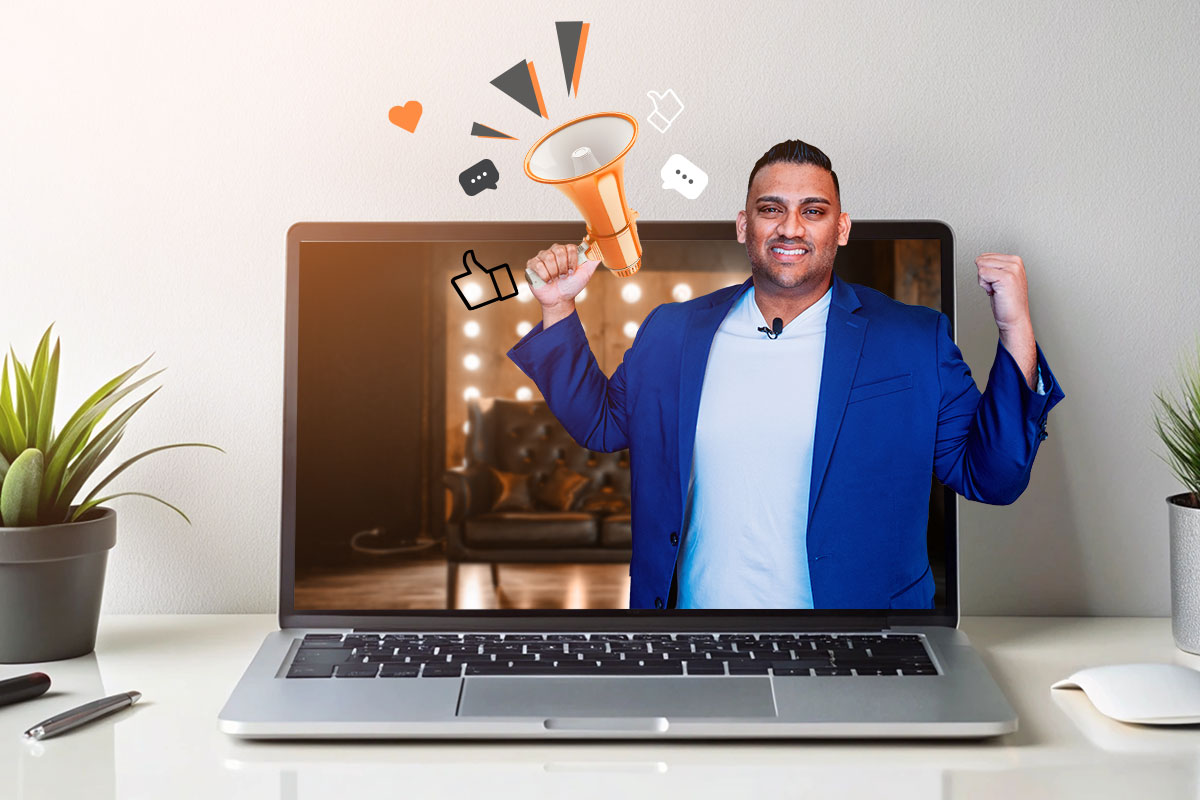 Photo booth owner coming out of a laptop screen holding a megaphone