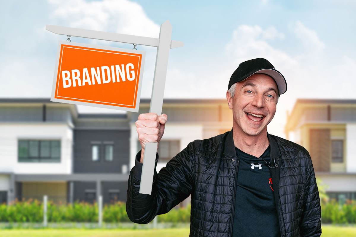 Real estate business owner holding a sign that says "branding"