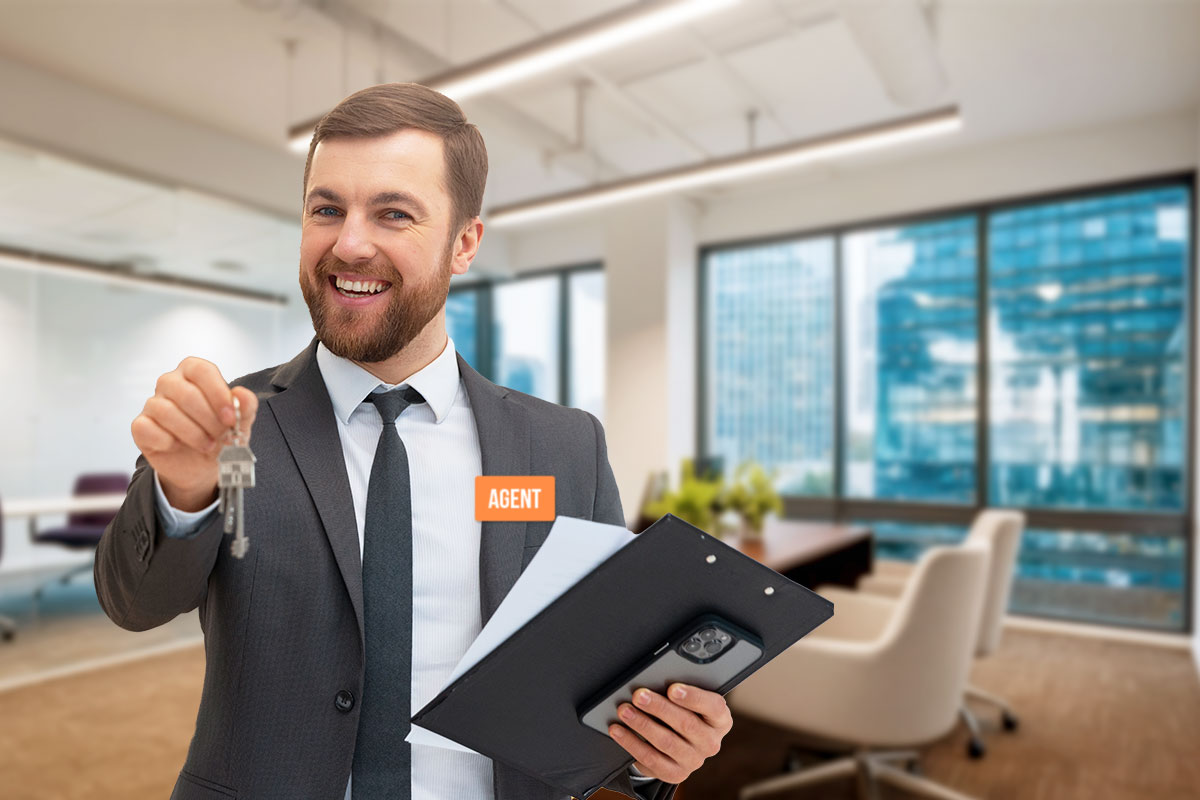 Real estate agent in a large office holding a clipboard and keys