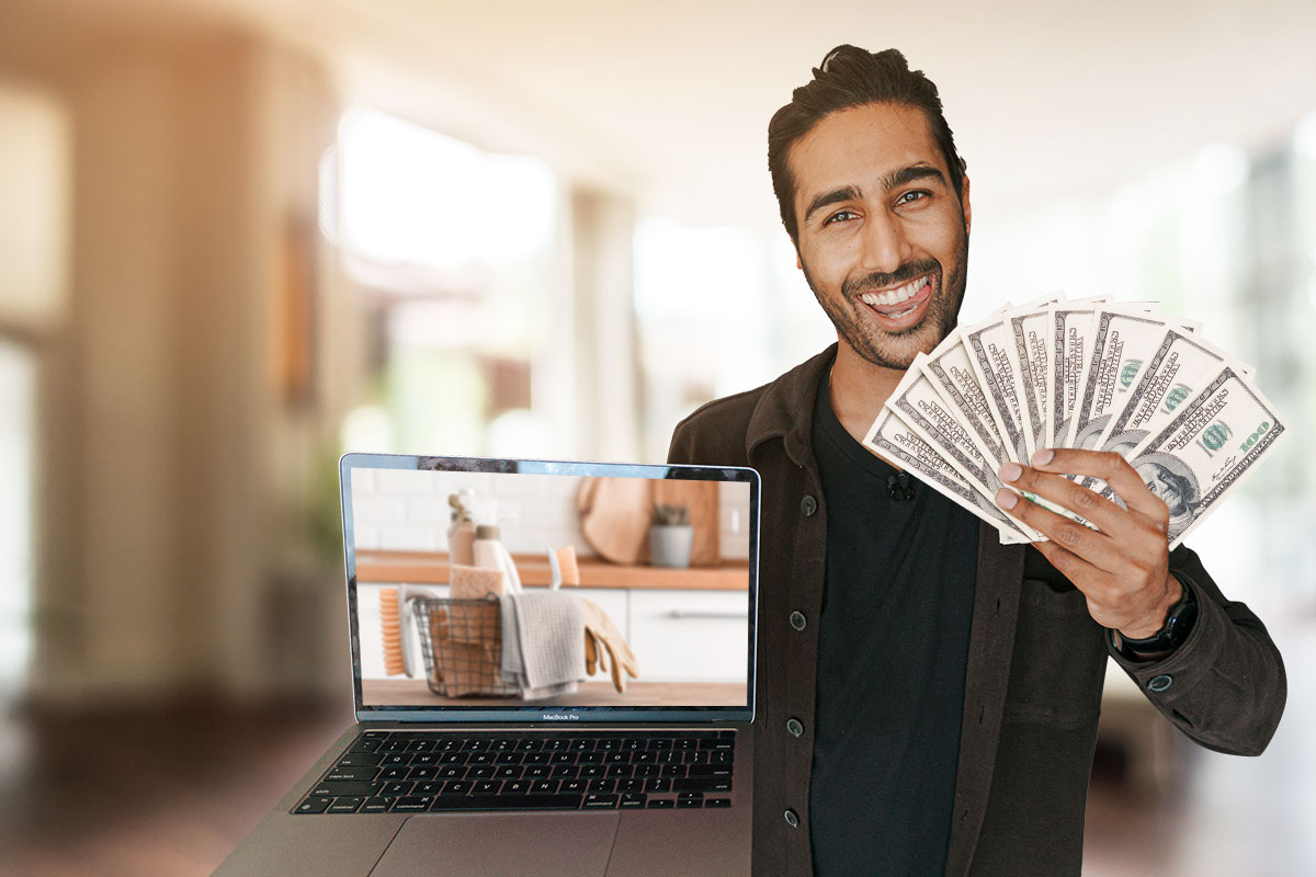 Owner of MaidThis posing with cash and a laptop showing cleaning products