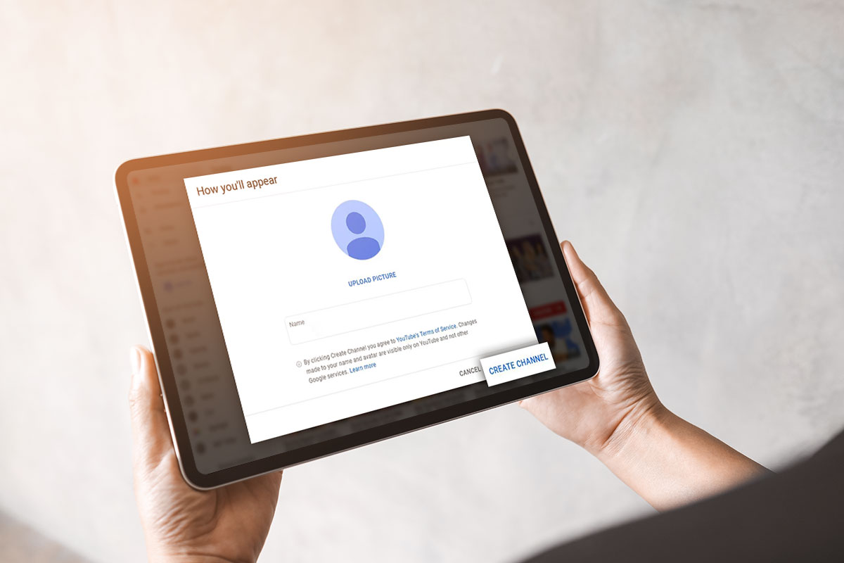 How to Start a $45K/Month YouTube Channel 5 A tablet open to a YouTube prompt to upload a profile picture and create a channel