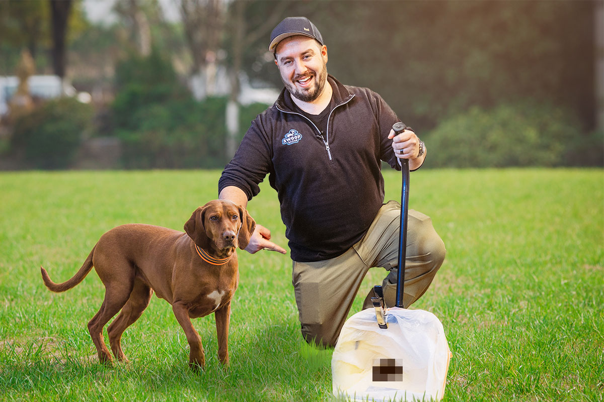 Owner of Swoop Scoop kneeling next to a dog while checking a yard for dog poop