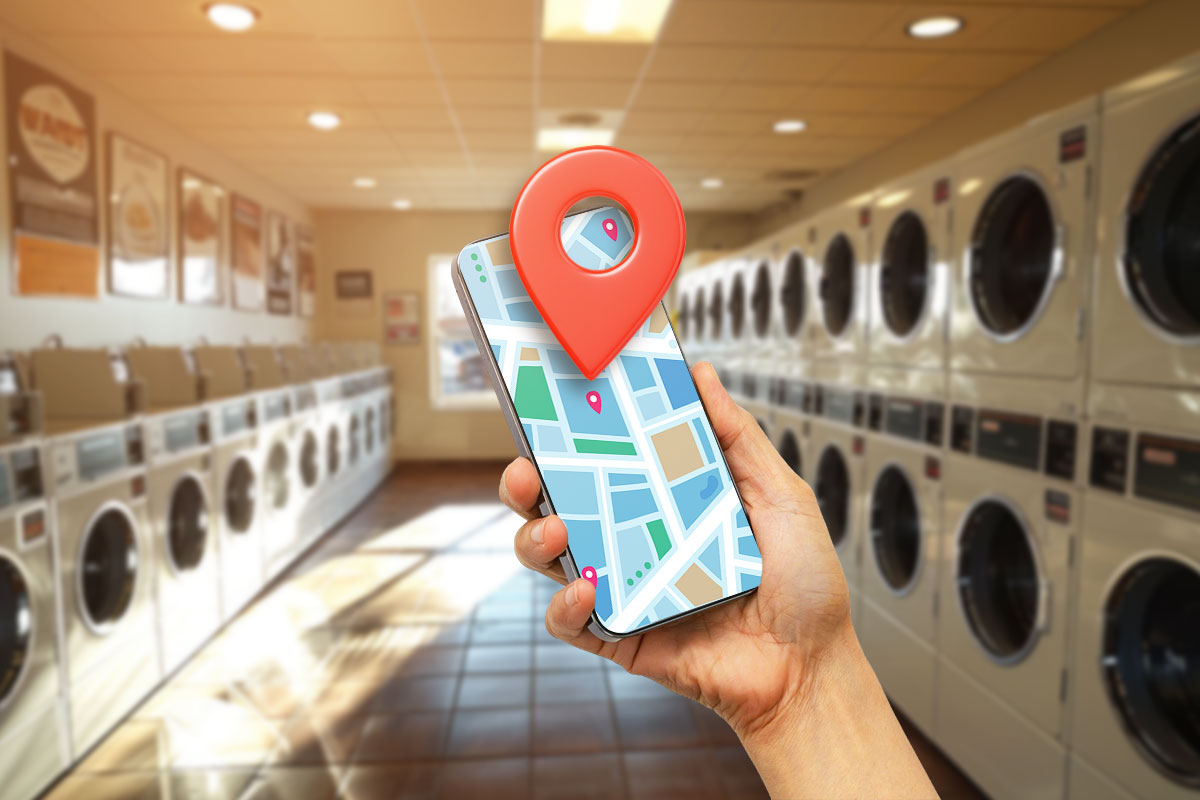 Laundromat Business Plan: Expert Advice From a $1.8M/Year Business Owner 7 A laundromat customer looking at a map on their phone with a large location pin marking their location
