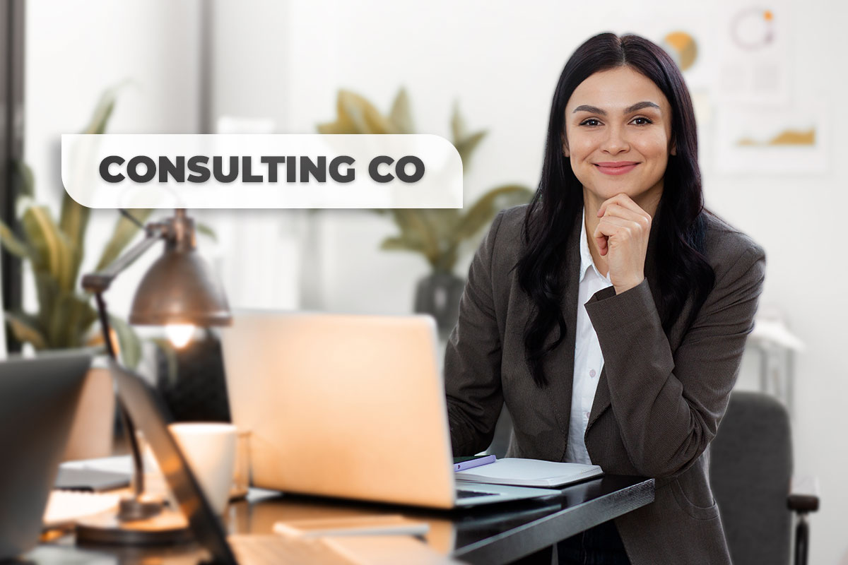 425 Consulting Business Names 1 A businesswoman in a suit working on a laptap next to a speech bubble that says Consulting Co.