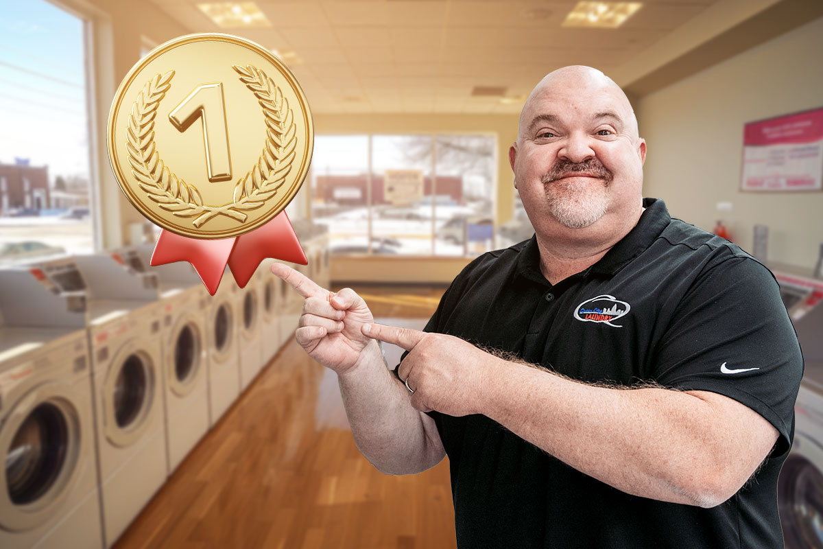 Laundromat Business Plan: Expert Advice From a $1.8M/Year Business Owner 9 The owner of Queen City Laundry pointing to a first place medal and ribbon