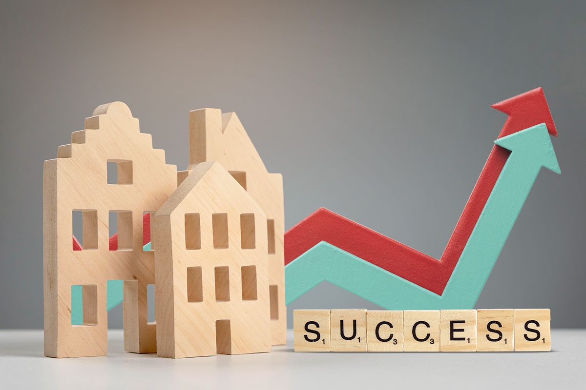 How to Start a $1.5M/Year Business From Home (in 9 Steps) 14 Three wooden block houses and upward-trending arrows showing growth next to Scrabble letters spelling out the word success.