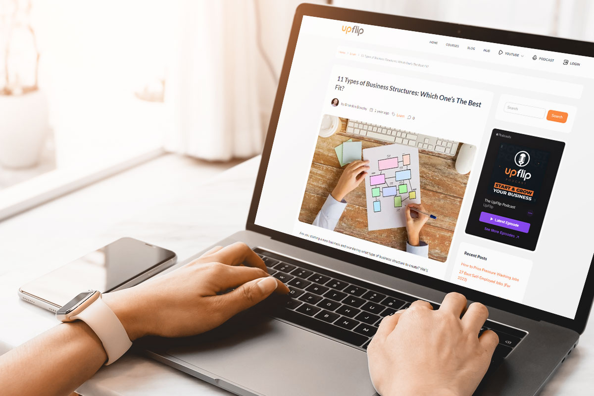 How to Start a $1.5M/Year Business From Home (in 9 Steps) 10 A business owner reading a laptop open to an UpFlip article about business structures.