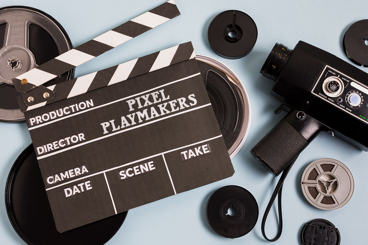 277 Digital Marketing Business Names 6 A wooden film clapper board with the name Pixel Playmakers sitting on a table with miscellaneous film equipment.
