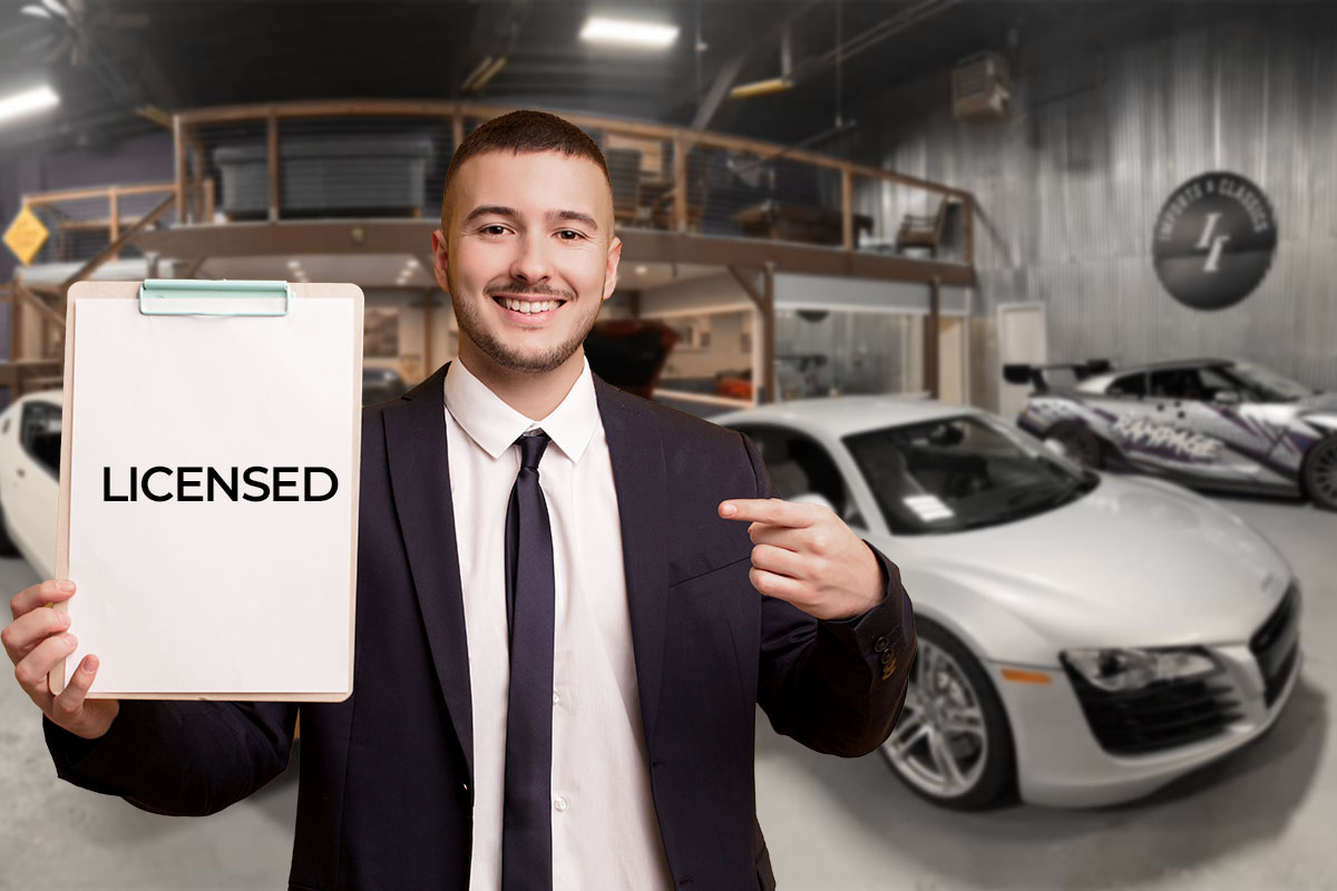 How to Start a Used Car Dealership 11 An employee standing next to cars for sale while holding a clipboard with a paper that says licensed.
