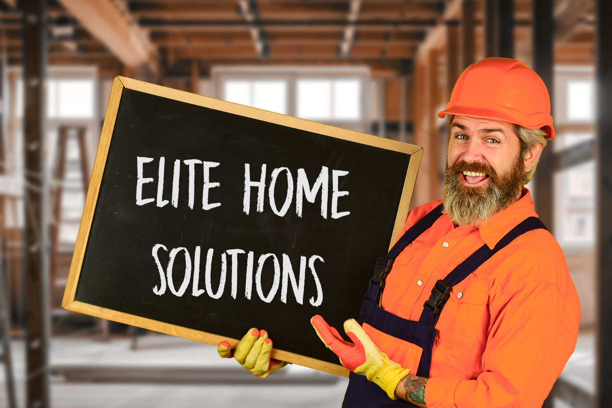 Handyman Business Names: 595 Unique Names 8 A handyman in a hard hat and gloves holding a chalkboard with the name Elite Home Solutions.