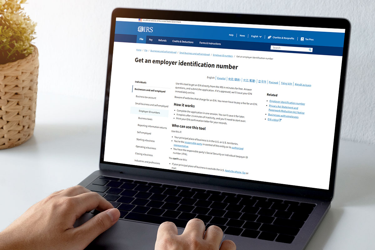 How to Start a Used Car Dealership 10 A laptop open to the IRS page about obtaining an employer identification number.