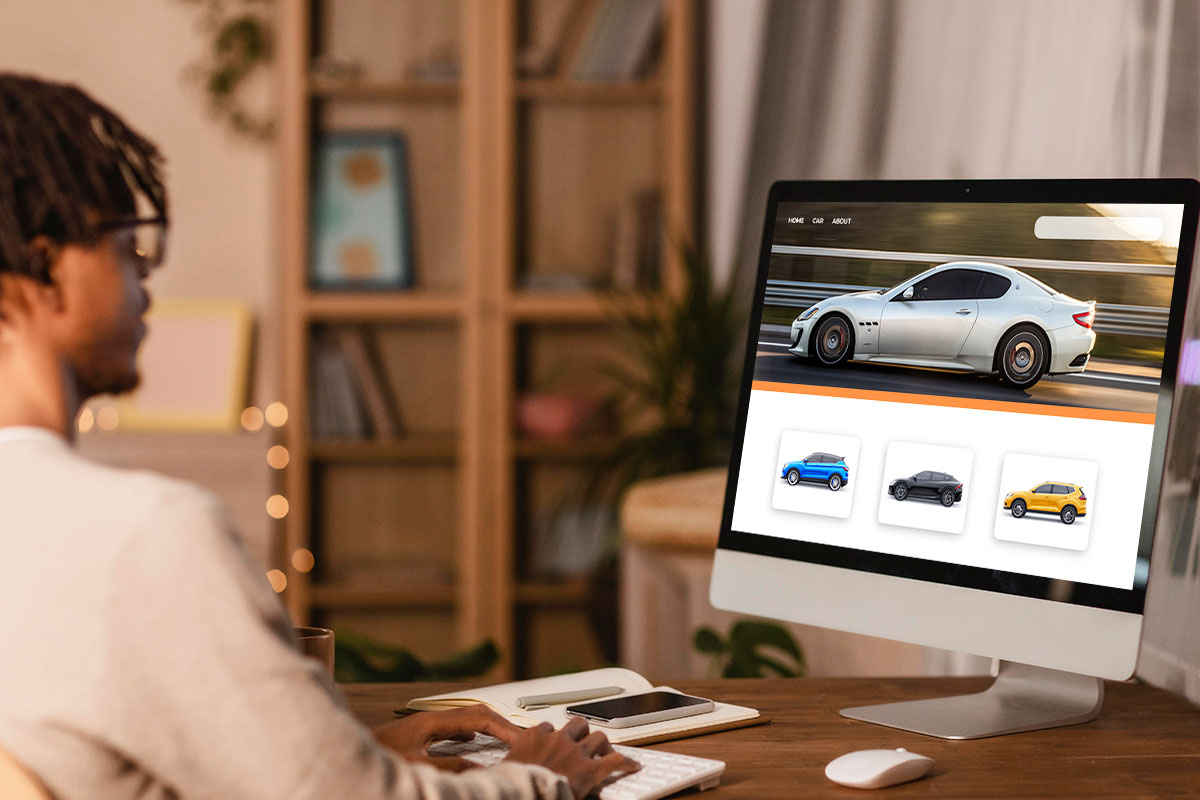 How to Start a Used Car Dealership 18 A customer on a computer looking at different cars online.