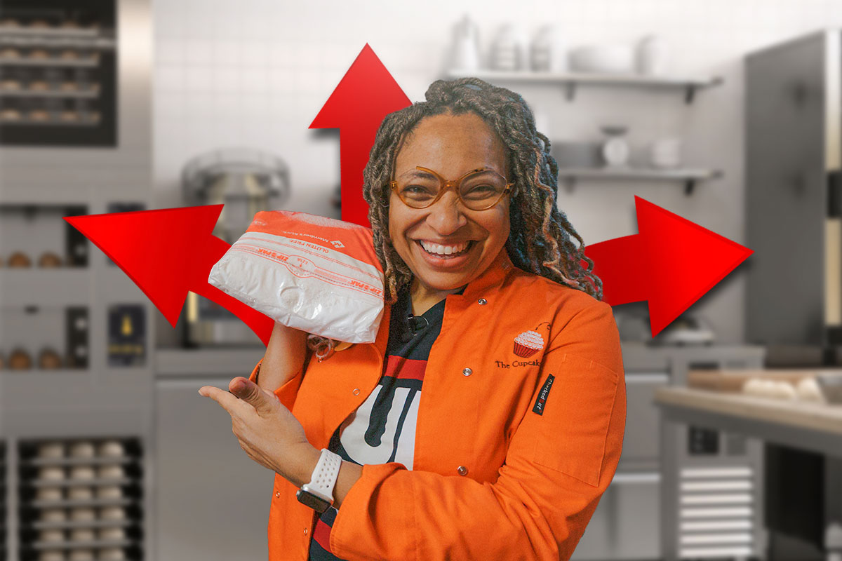 The owner of The Cupcake Collection holding a bag of sugar and pointing while cartoon arrows go in different directions from behind her.