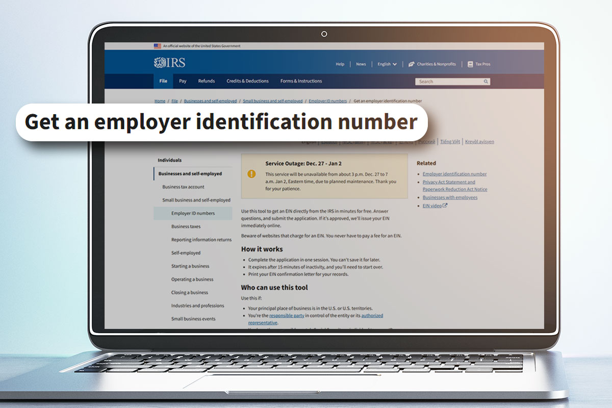 A laptop open to the IRS page about getting an employer identification number.