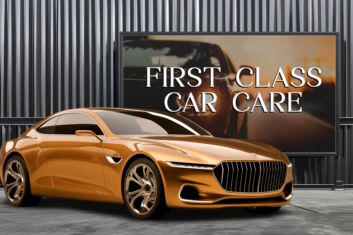 A sign that says First Class Car Care hanging above a luxury vehicle.