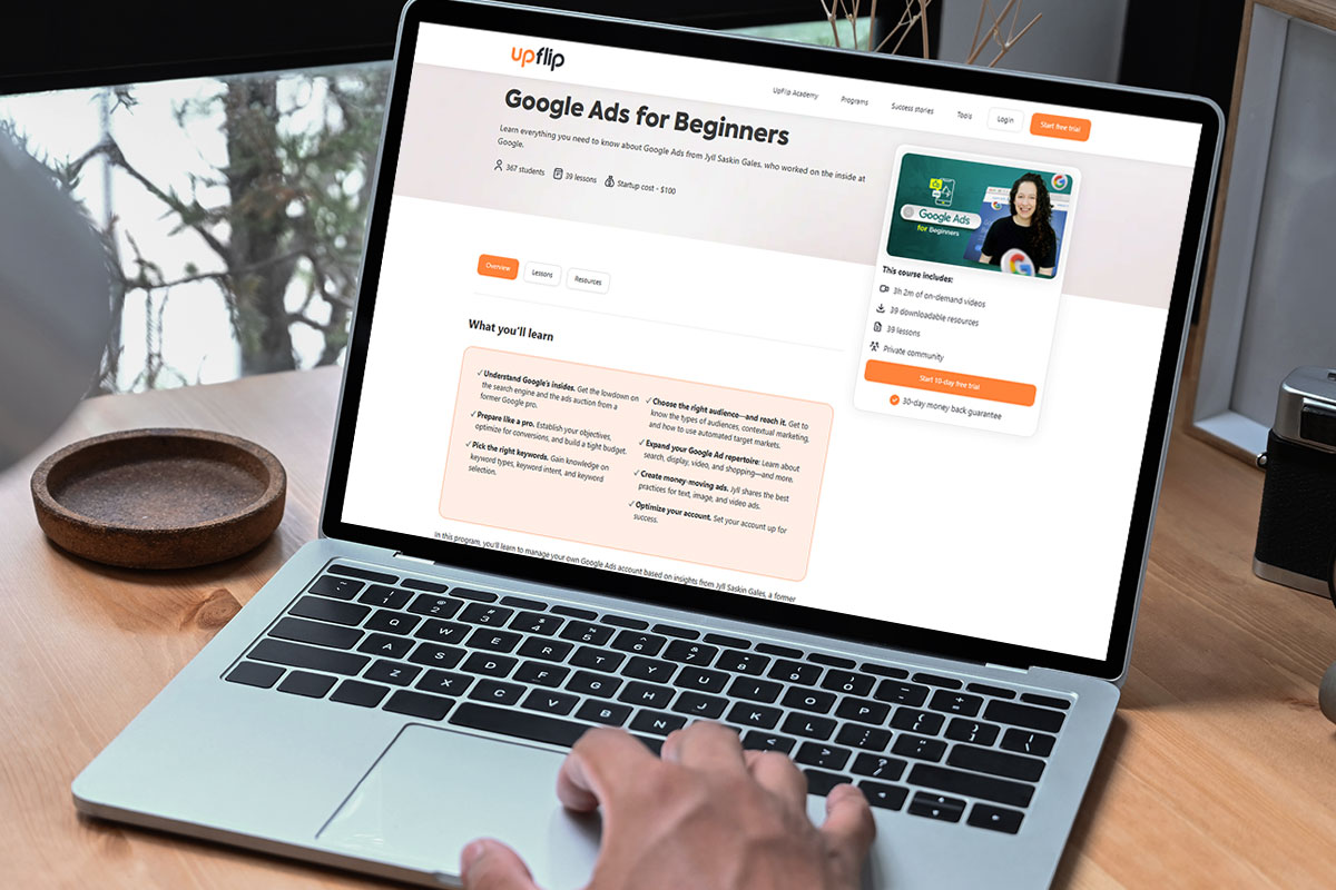 A laptop on a table open to the UpFlip Academy Google Ads for Beginners course.