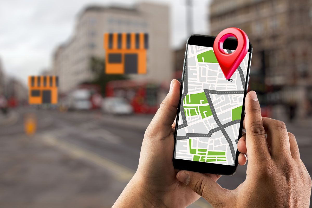 A mobile phone showing a map with a three-dimensional location pin coming out of the screen.