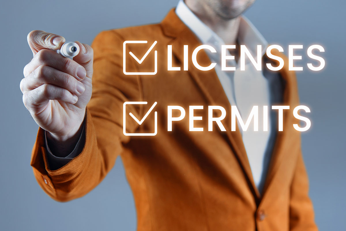 306 Best Construction Company Names 9 A businessman in a suit using a marker to check off licenses and permits.