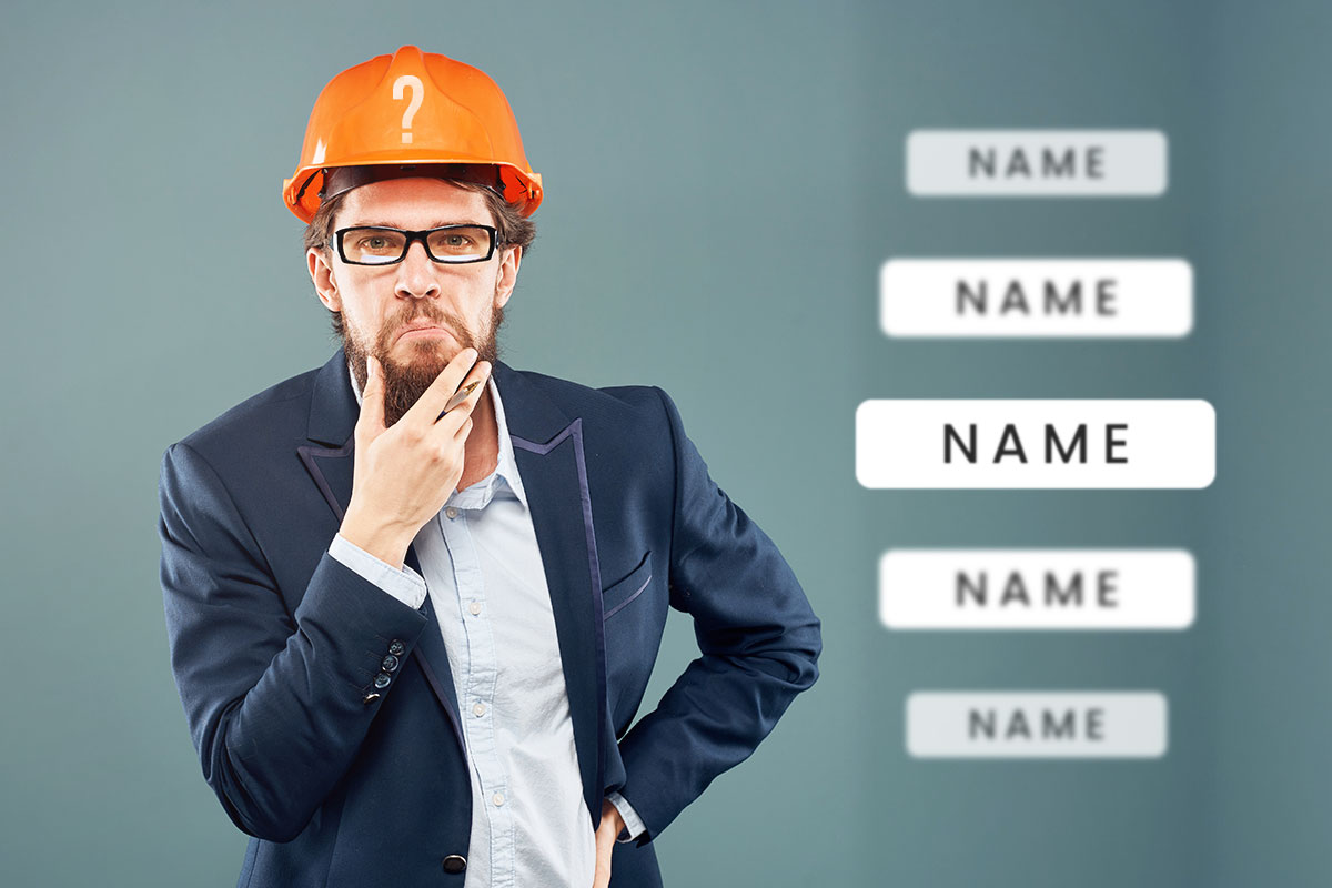 306 Best Construction Company Names 7 A businessman in a suit and hard hat holding his chin while thinking about name ideas.