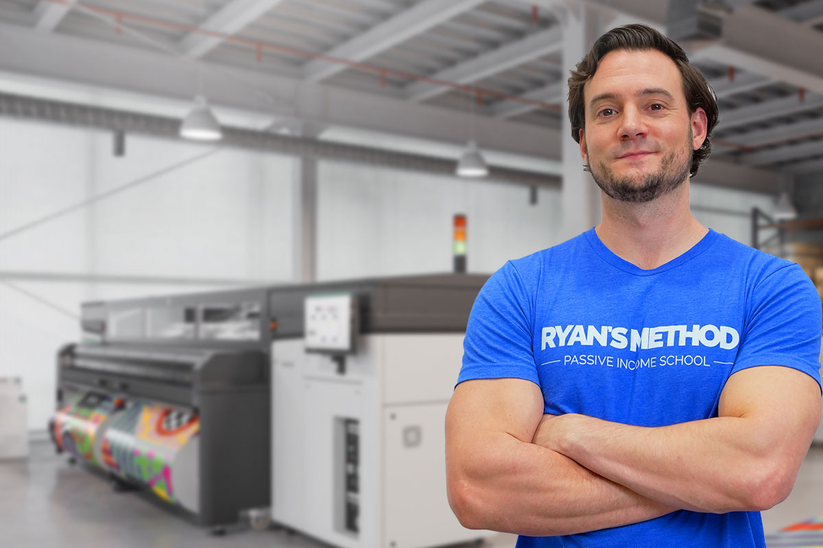Ryan Hogue standing in front of equipment for his print-on-demand business.