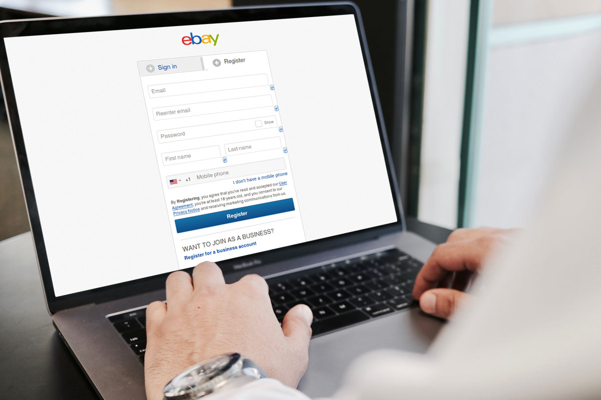 A business owner registering for an eBay account on a laptop.