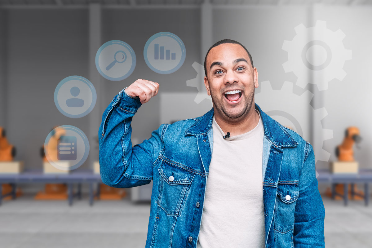 A businessman flexing his bicep in front of an automated assembly line.