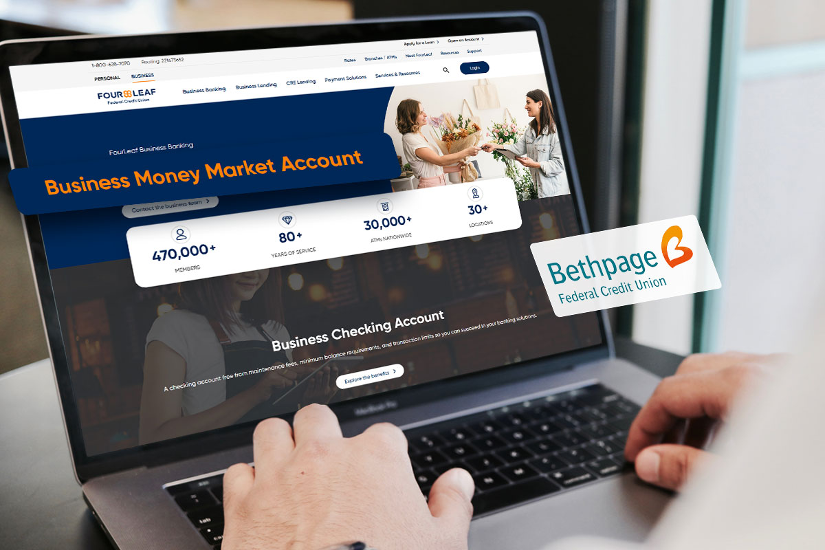 A business owner using a laptop to read about the business money market account offered by Bethpage Federal Credit Union.