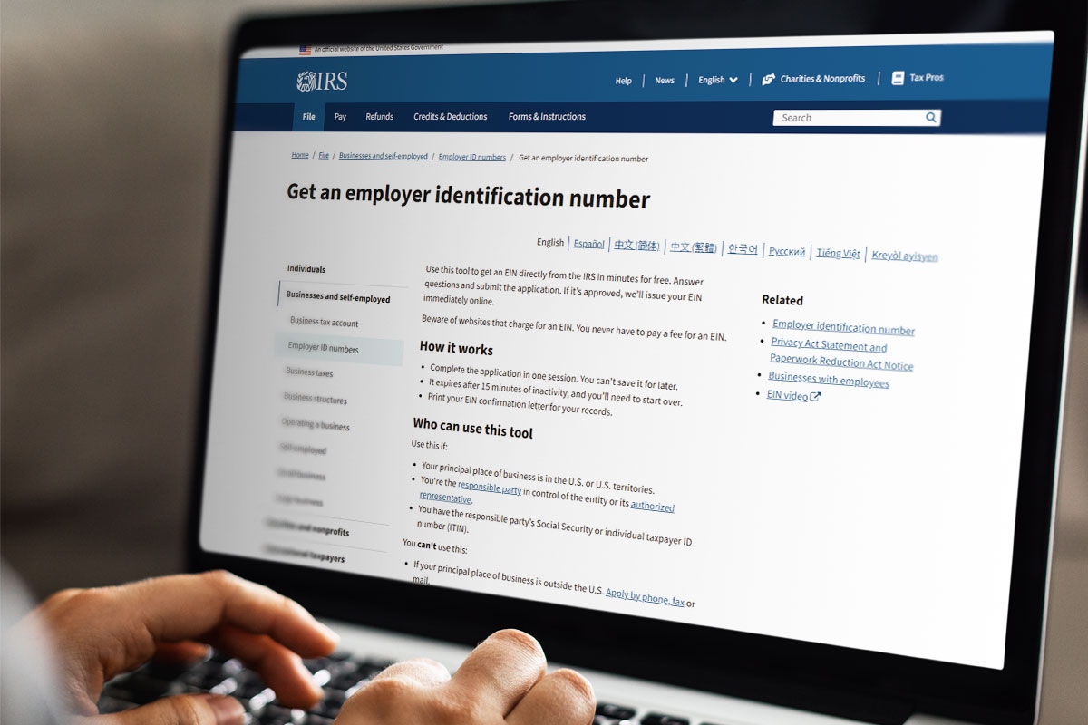 How to Start a Clothing Boutique (and Make $102K/Month) 9 A business owner using a laptop to read about employer identification numbers on the IRS website.