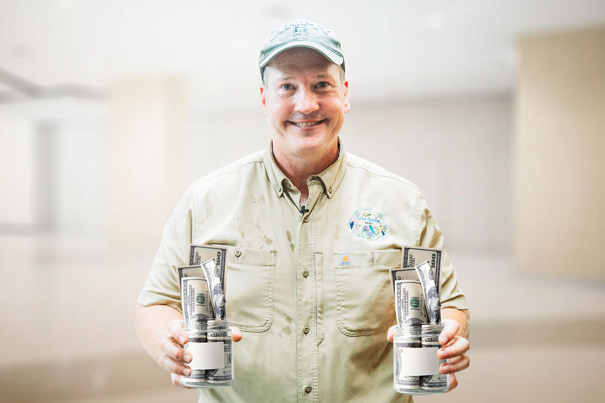 Grants 101 for Small Business Owners 80 The owner of Secret Garden Bes holding two jars full of cash.