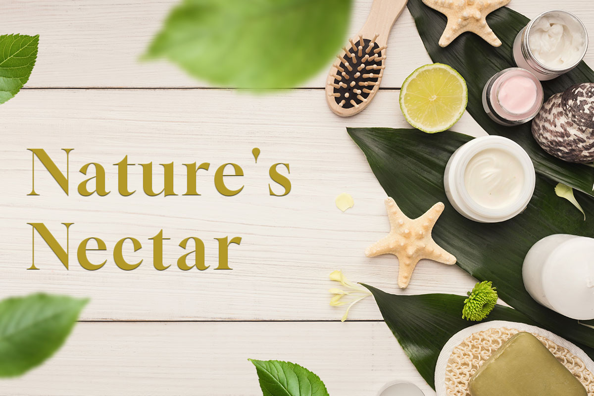 387 Beautiful Esthetician Business Names 9 An assortment of soaps, creams, and supplies on a table next to the name Natures Nectar.