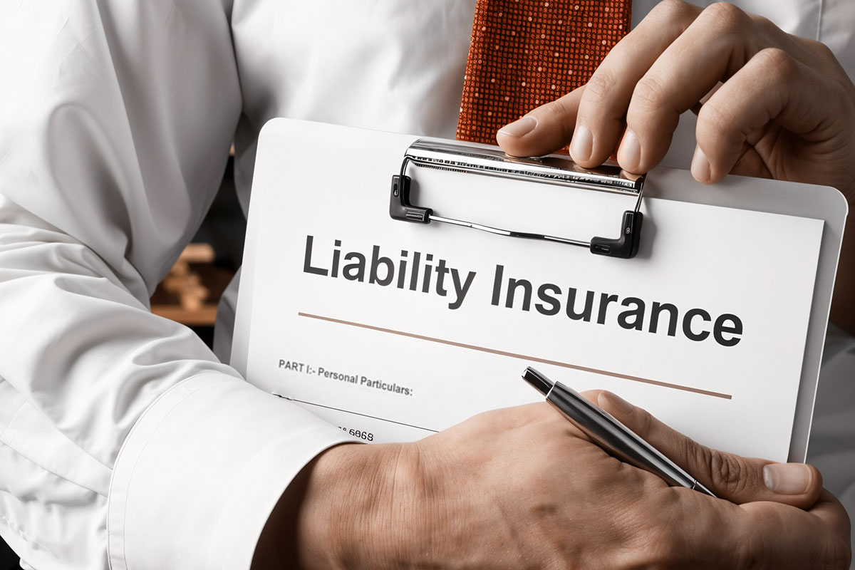 A businessman filling out a liability insurance application on a clipboard.