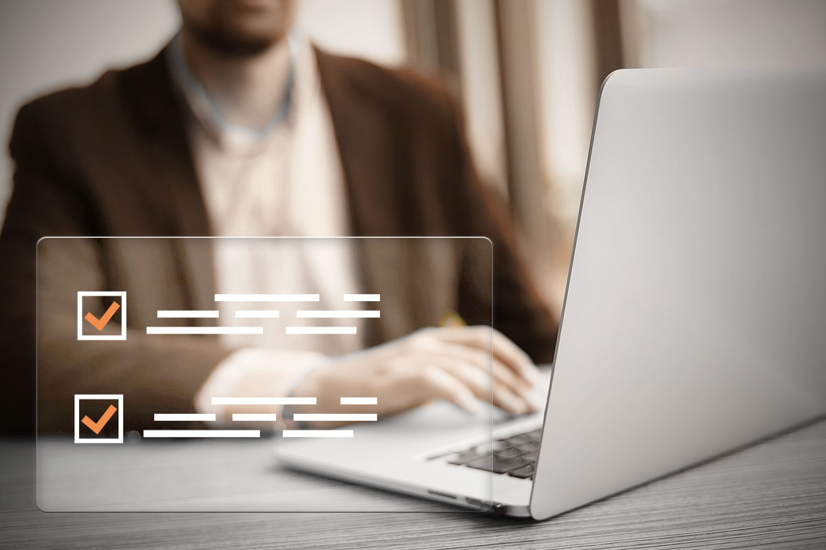 A business owner on a laptop completing a checklist.